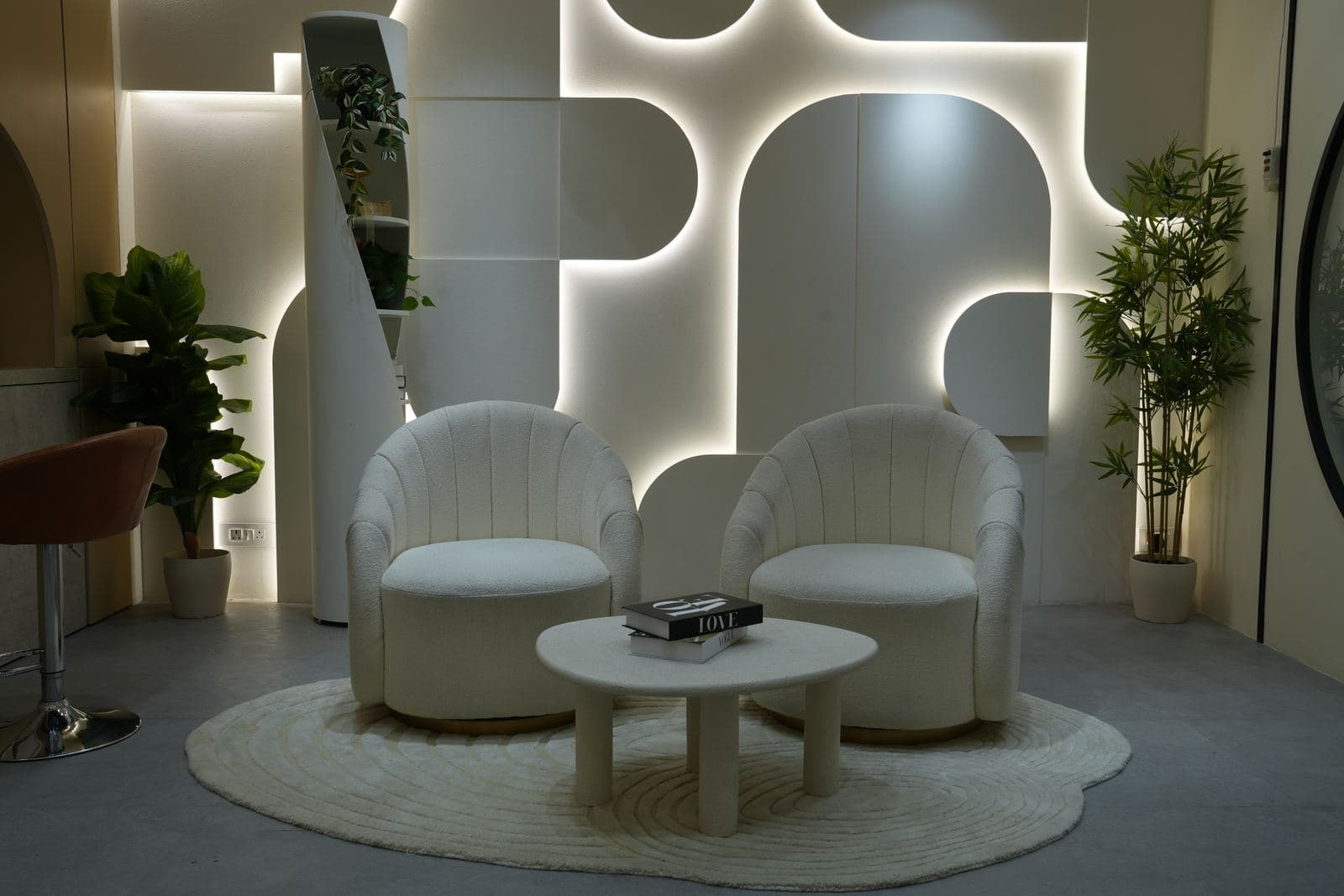 The podcast set from closer in, the backlit arch panels running the full width behind both chairs.