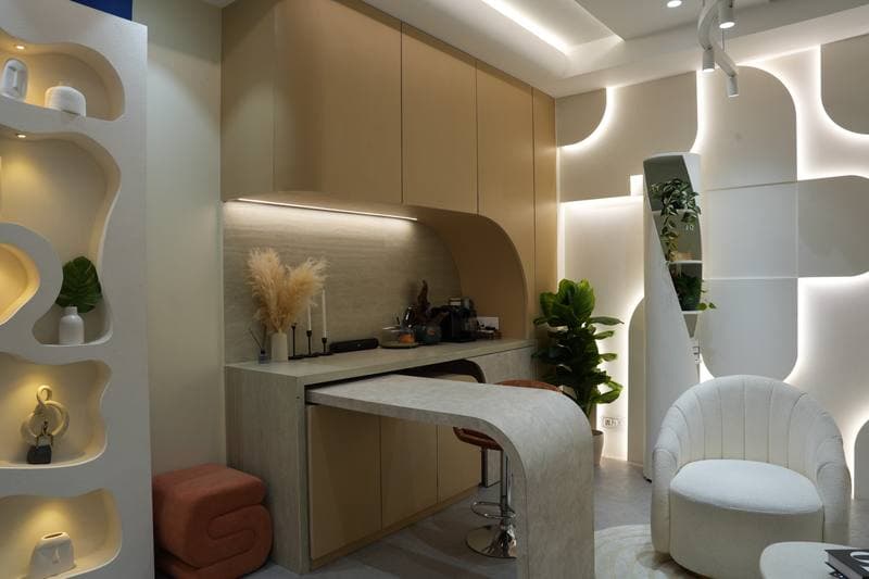 Endura's kitchen set — a stone-look counter with built-in lighting, beside the studio's lit niche wall.