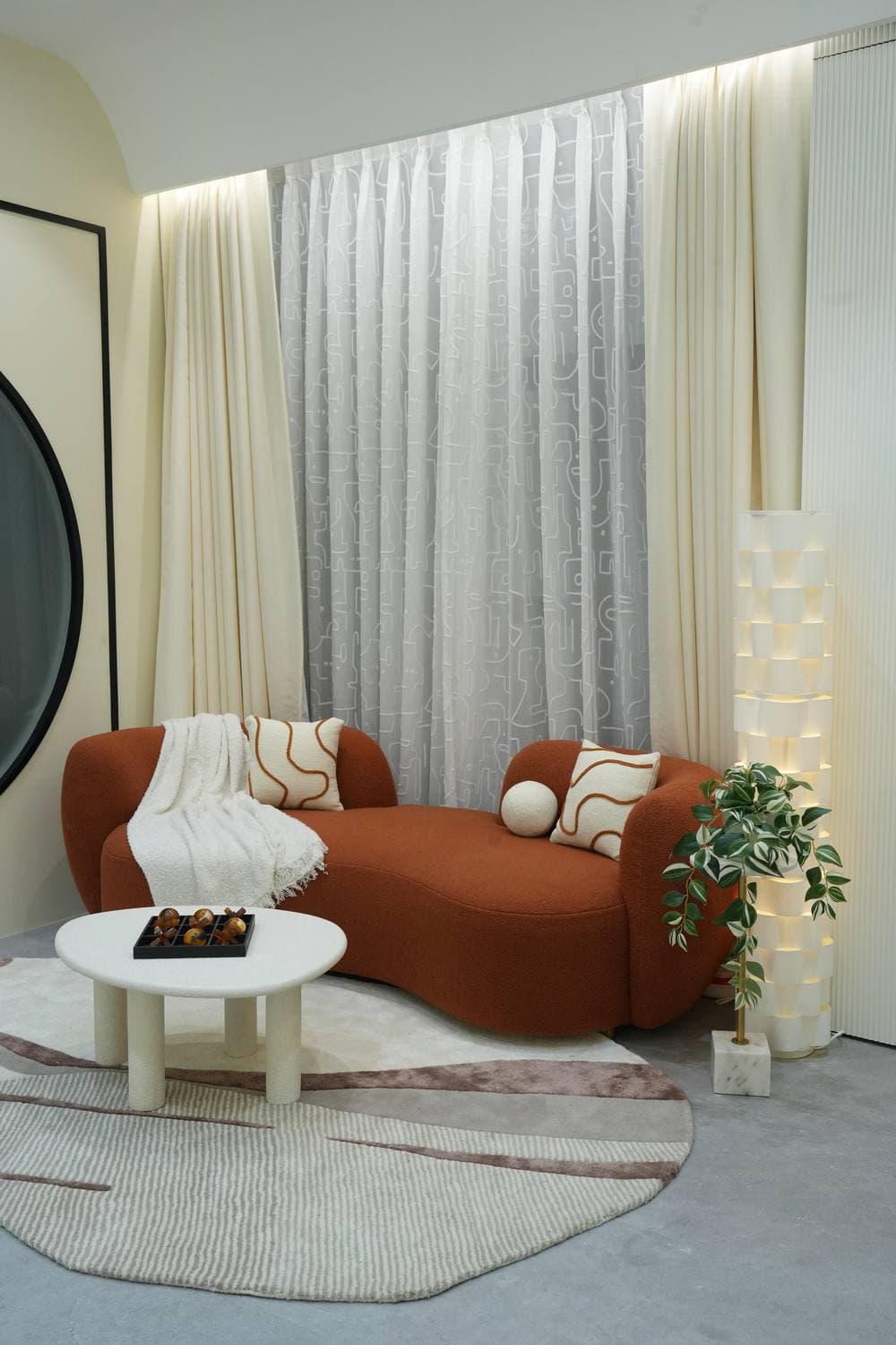 The rust sofa in Endura's living room set, lit and styled — the studio the agency shoots in.